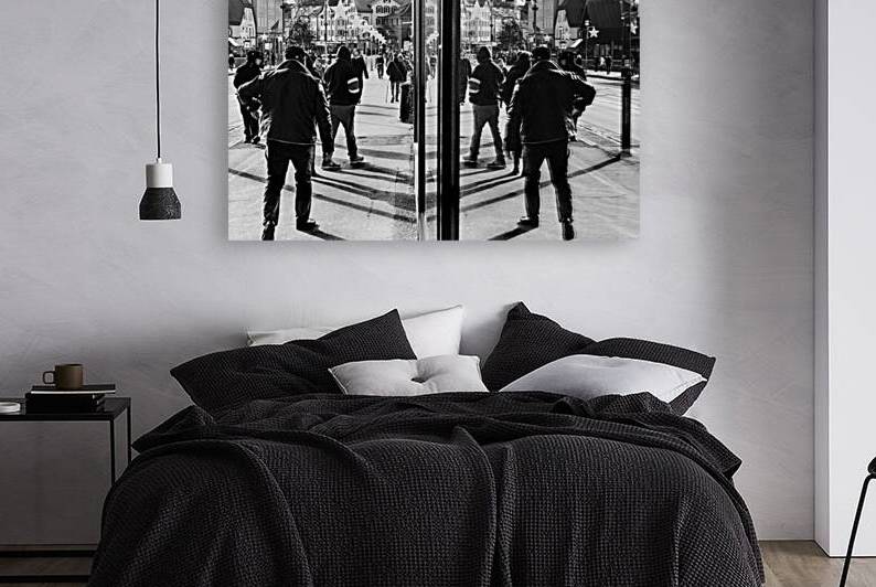 Black and white street photo of people being reflected in a shop window by caladoart