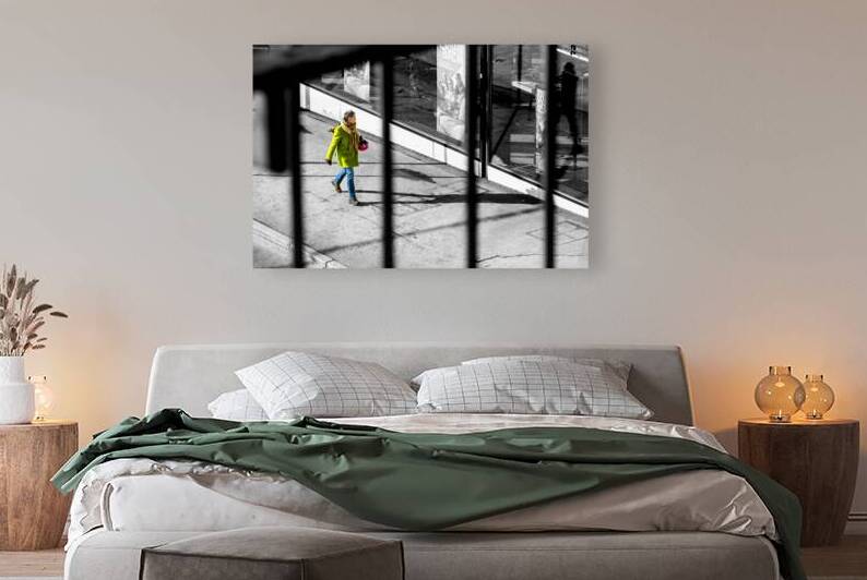 Selective colour black and white shot of a woman in a green coat walking down the street  by caladoart