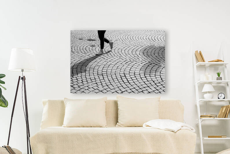 Street scene of a person walking on cobblestone  by caladoart