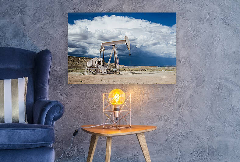 Oil pump in the desert with menacing clouds in the background by caladoart