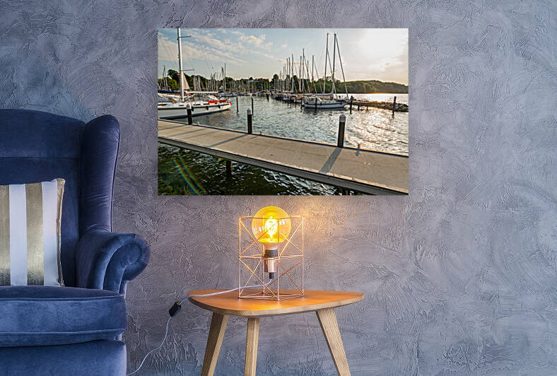 Sailing boats and pier in a marina Langballigau during sunset at the Baltic Sea in Northern Germany by caladoart