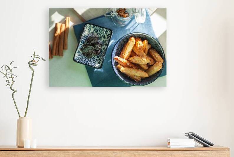 Choux pastry sticks in a ceramic bowl next to them are cinnamon by Dariusz Banaszuk