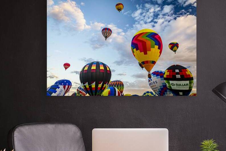 Colorful hot air balloons floating in a clear blue sky during su by Gestalt Imagery