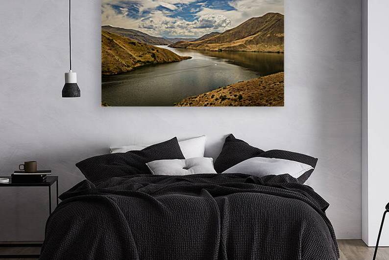 Boater on the beautiful Snake River amidst scenic hills and clou by Gestalt Imagery