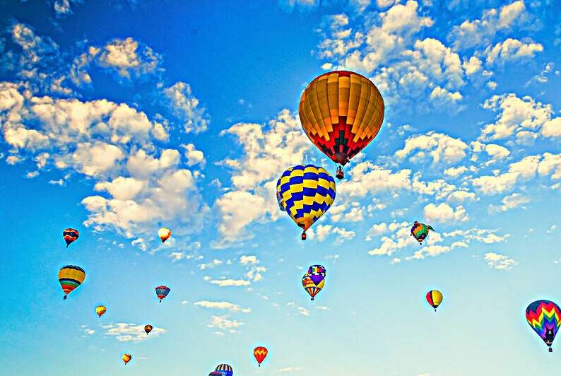 Colorful Hot Air Balloons Floating in the Cloudy Blue Sky by Gestalt Imagery