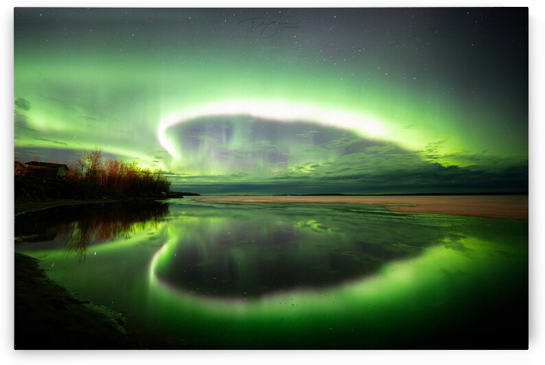 Radiant Northern Lights casting ethereal hues over a frozen Pinehouse Lake Saskatchewan. Captured by Dre Erwin this celestial dance illuminates the wintry night sky painting an awe-inspiring spectacle of natures brilliance by Dre Erwin Photography