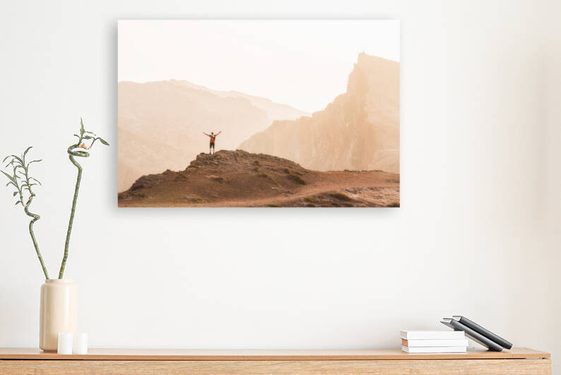 Hiker stretching arms in the air by Mikael Svensson