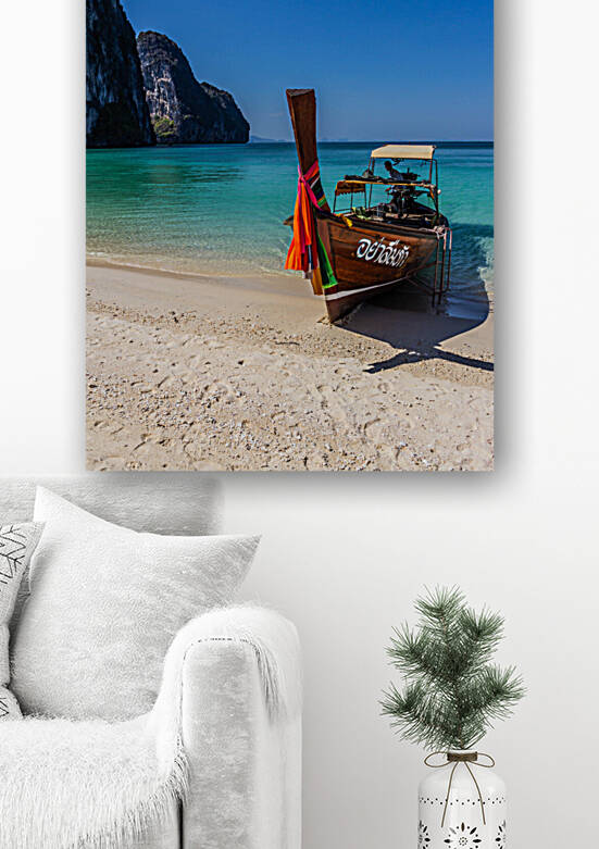 Long tail boat on white sand beach by Kevin Hellon