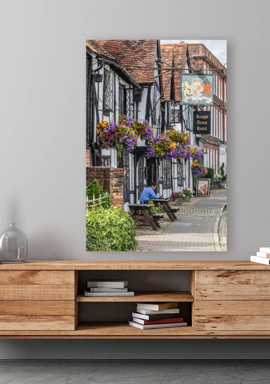 A man sits outside the Kings Arms Hotel in Amersham old town by Kevin Hellon