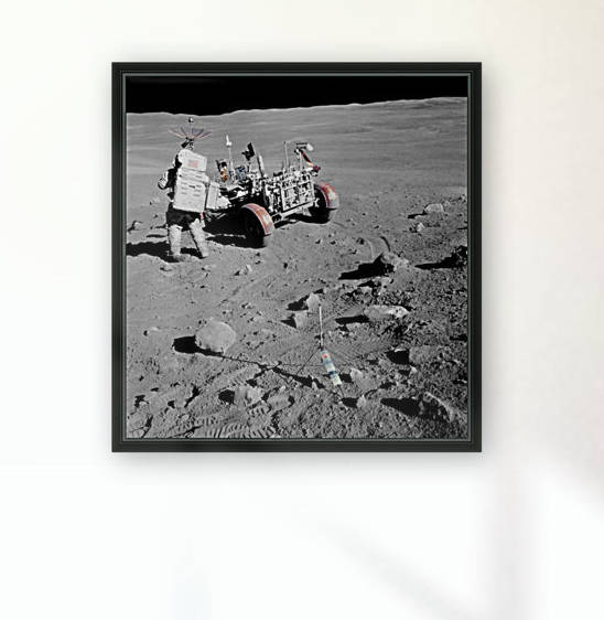 Apollo 16 astronaut stands near the Lunar Roving Vehicle. by StocktrekImages