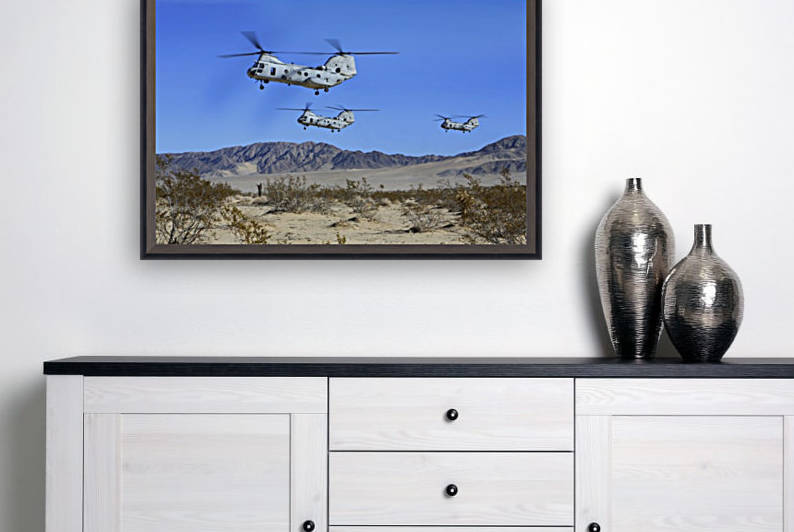 CH-46E Sea Knight transport helicopters fly over Camp Wilson. by StocktrekImages