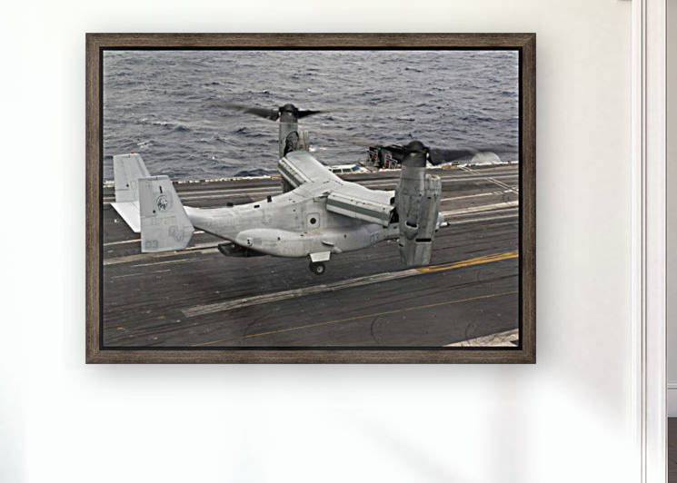 A V-22 Osprey lands aboard the aircraft carrier USS Harry S. Truman. by StocktrekImages