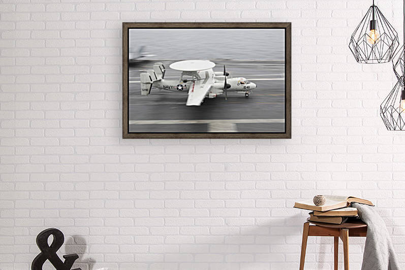 An E-2C Hawkeye lands aboard the aircraft carrier USS Harry S. Truman. by StocktrekImages