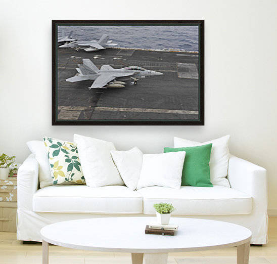 An F-A-18F Super Hornet lands on the flight deck aboard USS Nimitz. by StocktrekImages