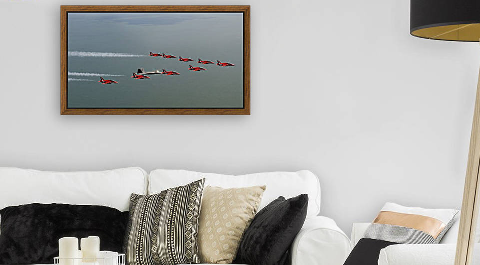 A F-22 Raptor flies in formation with the Royal Air Force Aerobatic Team The Red Arrows. by StocktrekImages