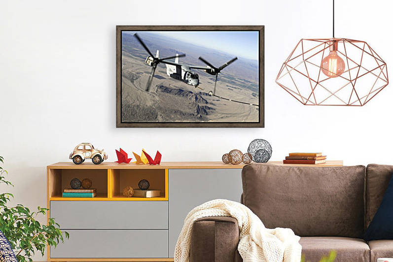 A Marine Corps MV-22 Osprey prepares to refuel midflight. by StocktrekImages