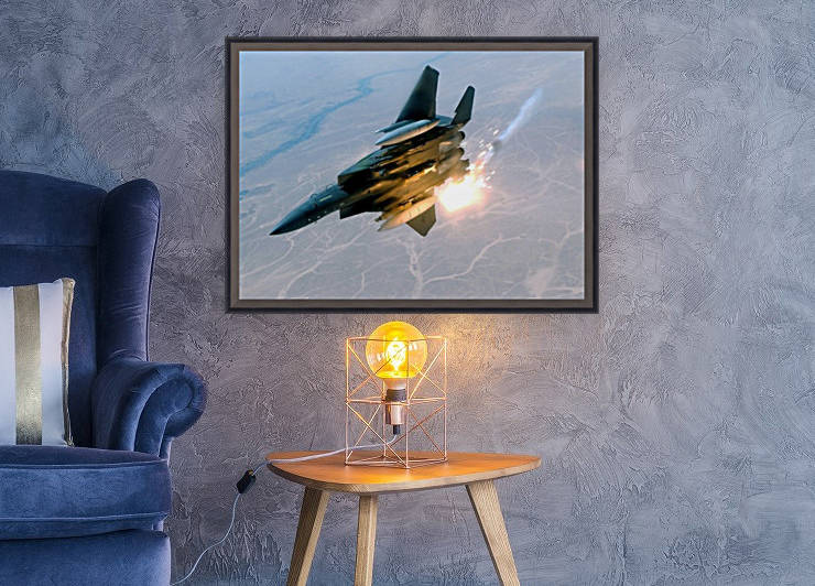 An F-15E Strike Eagle pops flares during a combat sortie. by StocktrekImages