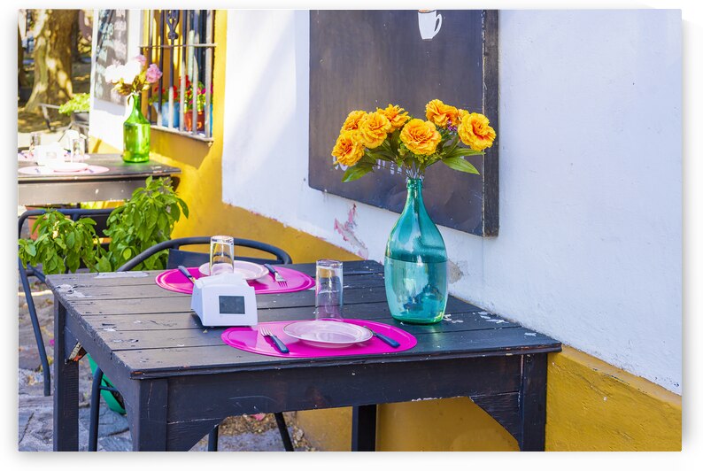 Uruguay restaurant table in Colonia Del Sacramento in historic center of Barrio Historico by Elijah Lovkoff