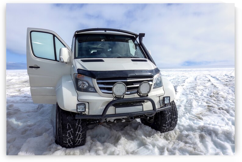 Glacier trucks and special cars driving people over Langjokull Glacier to man made ice tunnels by Elijah Lovkoff