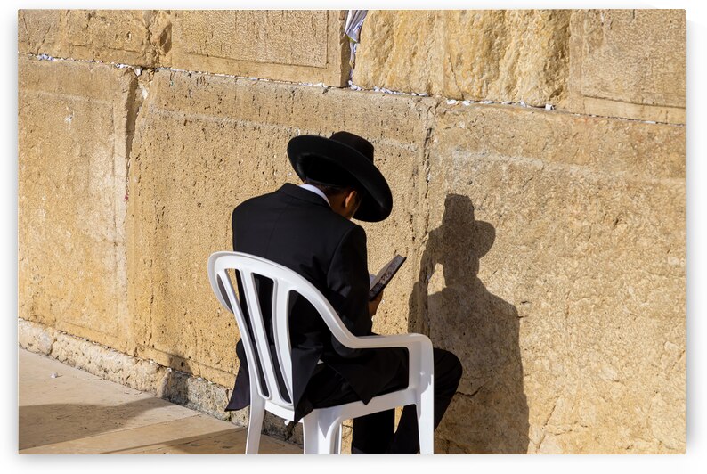Orthodox jew is praying in front of Sacred Western Wall in Jerusalem Old City Jewish Temple by Elijah Lovkoff