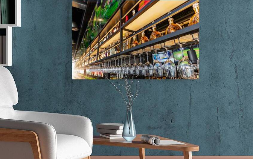 Miami Florida restaurant bar with a variety of wine and liquor bottles and glasses on the shelves by Elijah Lovkoff