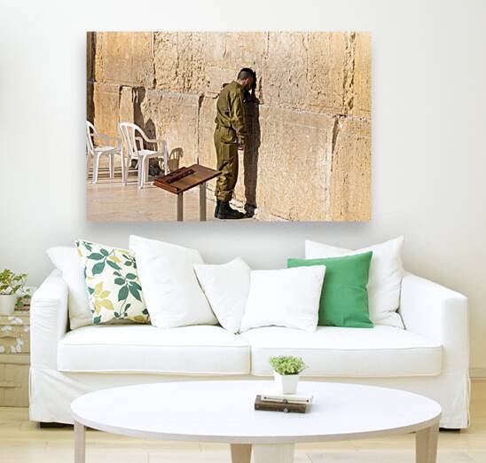Israeli soldier praying in front of Sacred Western Wall in Jerusalem Old City Jewish Temple by Elijah Lovkoff