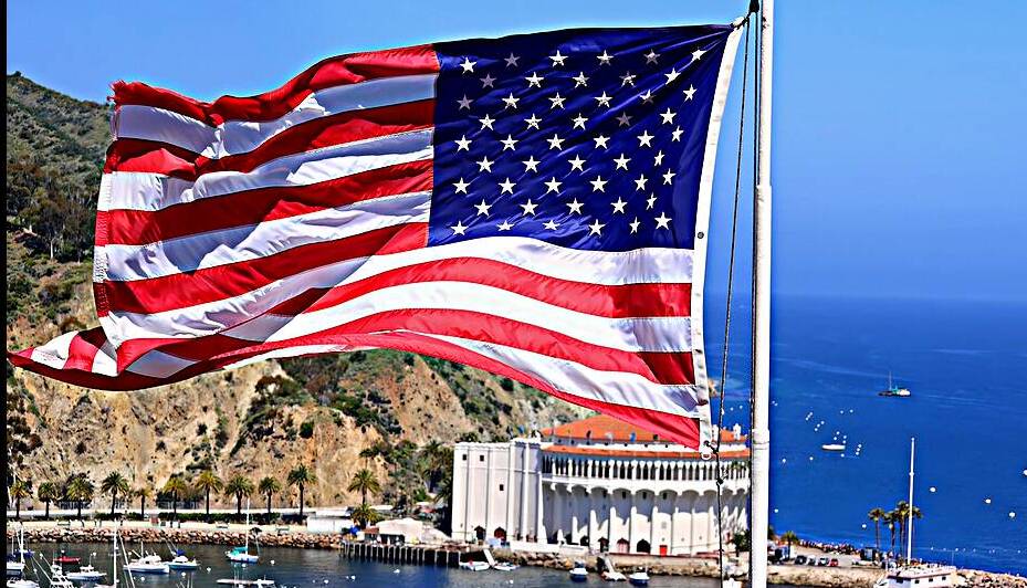 American star spangled flag waving in California. A large American flag is flying high above by Elijah Lovkoff