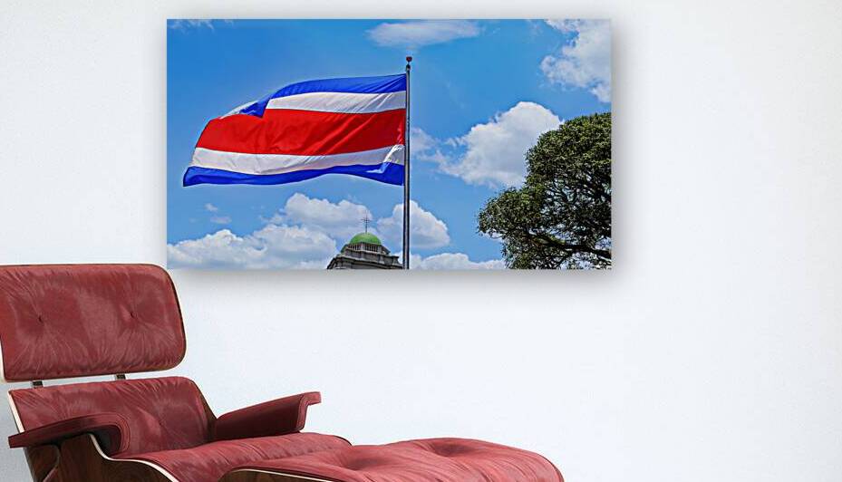 Costa Rica Flag proudly waving in San Jose. Large Costa Rica flag is flying high in city center by Elijah Lovkoff