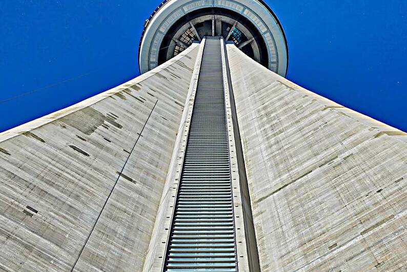 Toronto Canada 26 July 2018: Famous CN Tower overlooking Ontario Lake by Elijah Lovkoff