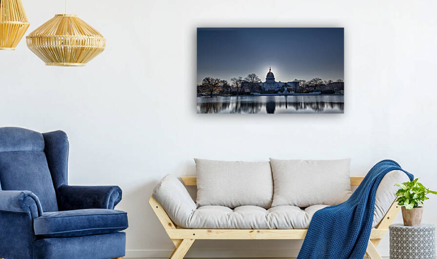Brightly lit dawn sky behind the illuminated dome of the Capitol in Washington DC with the pool and statues by artvi