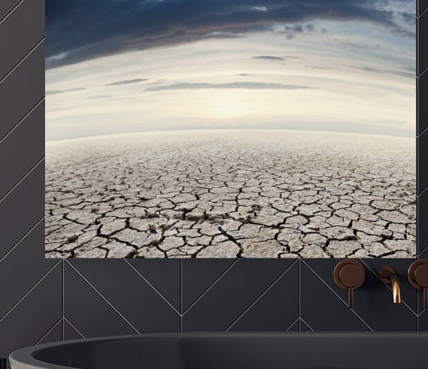 Desert landscape and sunset.Cracked soil by Carlos Castilla