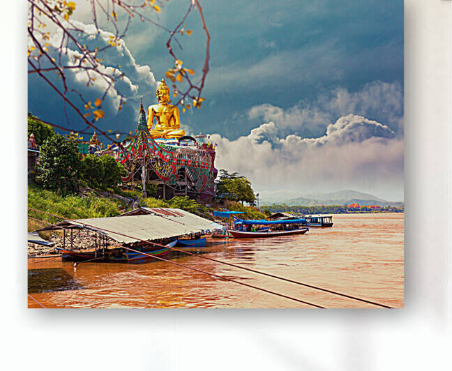 Golden giant Buddha statue on Mekong river. by Carlos Castilla