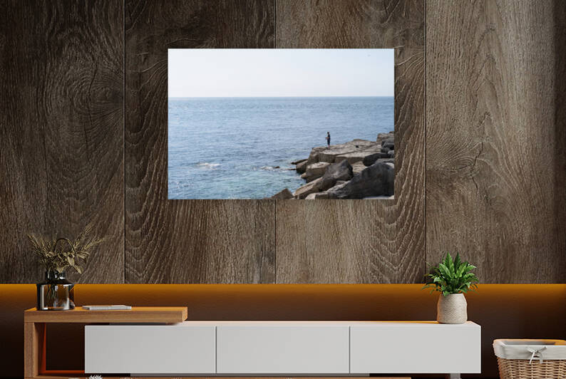 Fisherman standing on rocks at the sea near Portland Bill Lighthouse  Weymouth Dorset England by Leoniek Van Der Vliet
