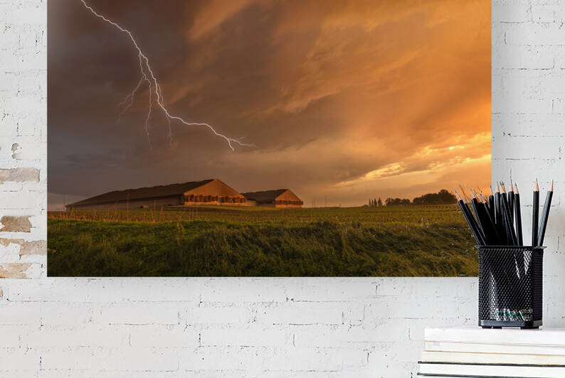 Lightning over grain storage facilities by Joe Belanger