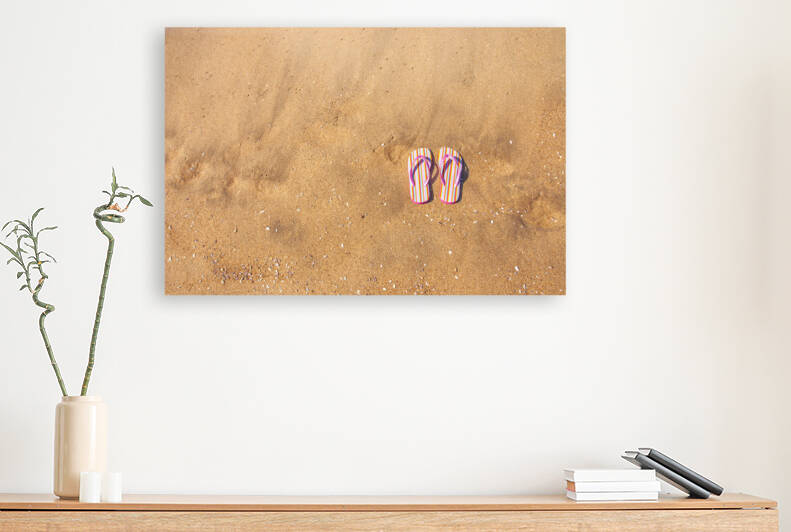 Flip flops on sand by Joe Belanger