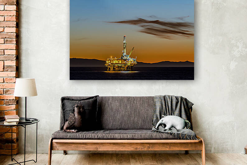 Offshore oil platform at dusk by Joe Belanger