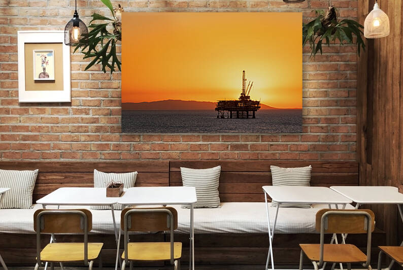Offshore oil platform at dusk by Joe Belanger
