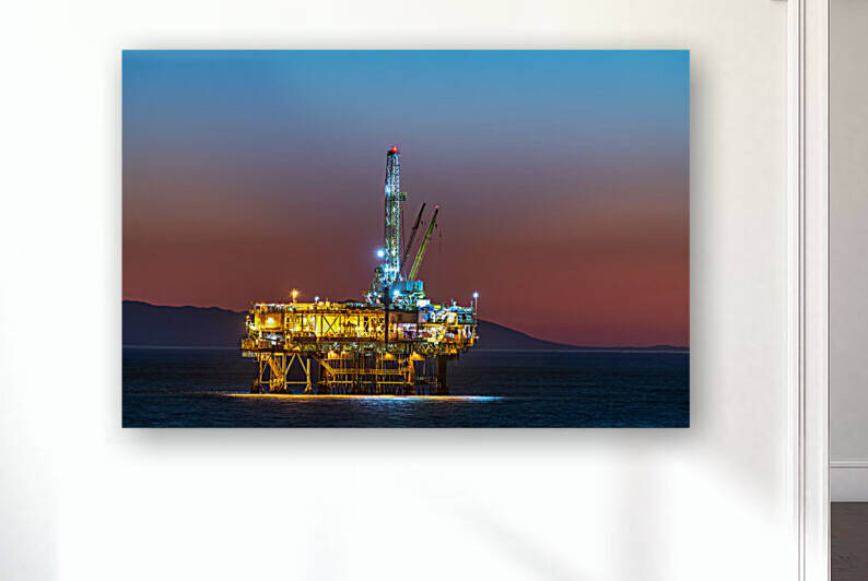 Offshore oil platform at dusk by Joe Belanger