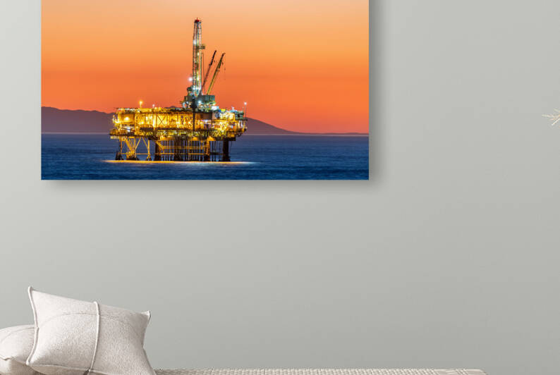 Offshore oil platform at dusk by Joe Belanger
