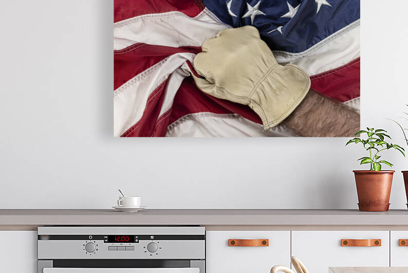 Man grasping American Flag by Joe Belanger