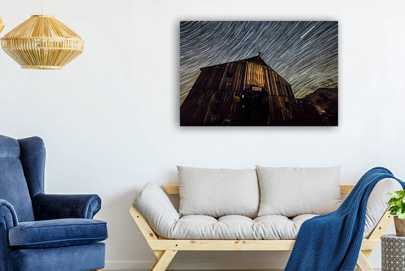 Star trails forming over barn by Joe Belanger