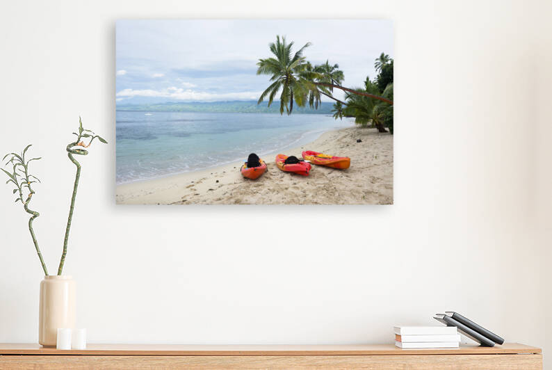 Kayaks on tropical beach by Joe Belanger
