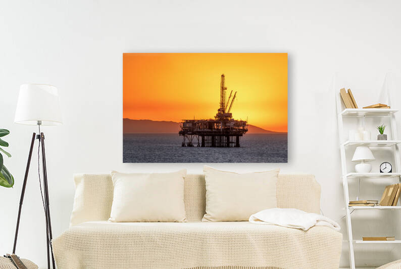 Offshore oil platform at dusk by Joe Belanger