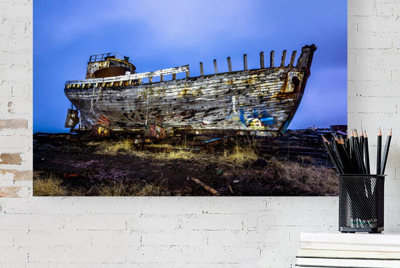 Old wooden ship on beach by Joe Belanger