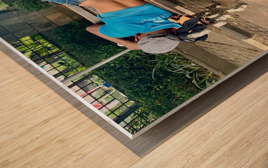 Napping on a Public Bench Jakarta Wood print