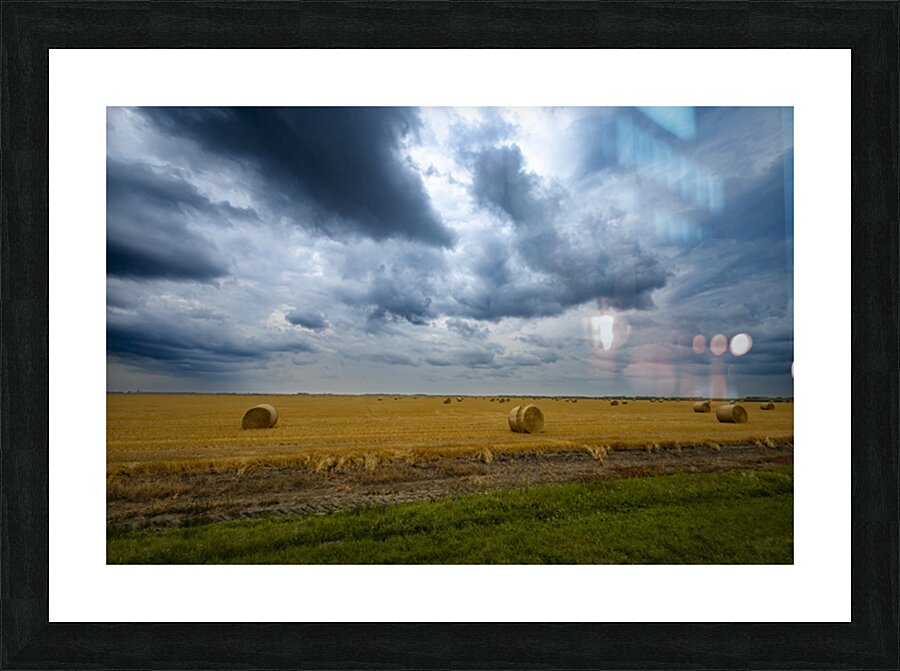 Hay Bales Under a Cloudy Sky Picture Frame print