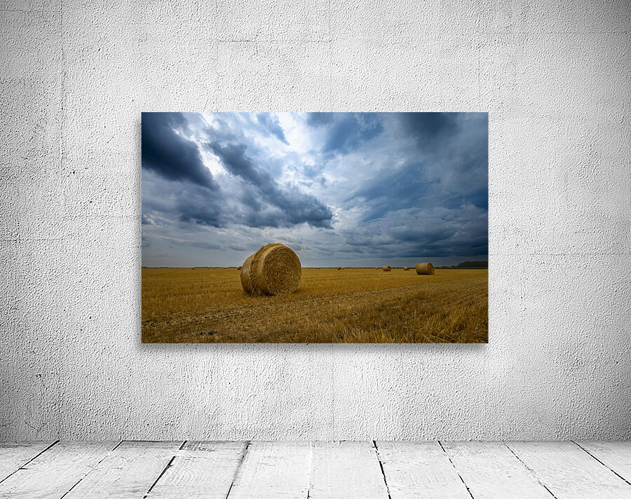 Hay Bales Under a Cloudy Sky Wall Preview