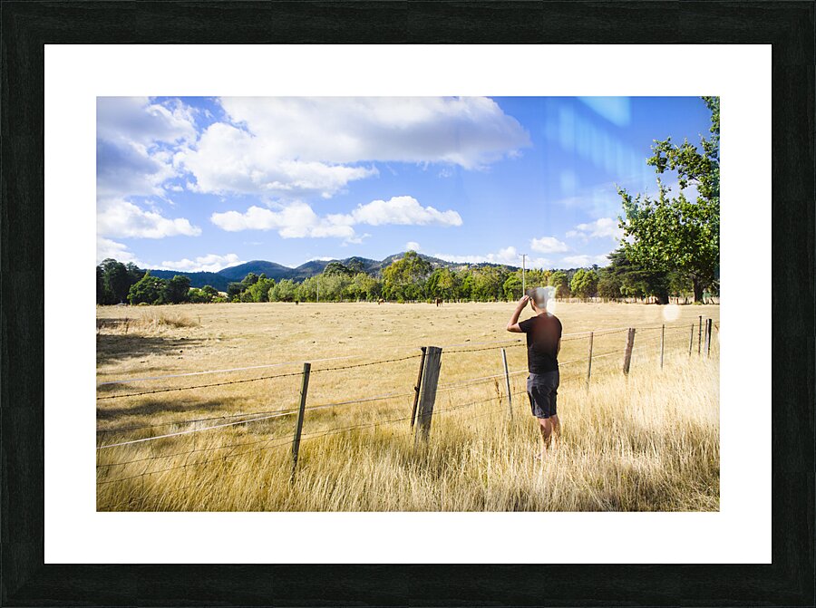 Man enjoying a rural farm landscape in Hobart Picture Frame print