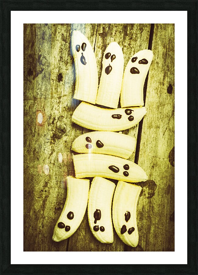 Bananas with painted chocolate faces Picture Frame print