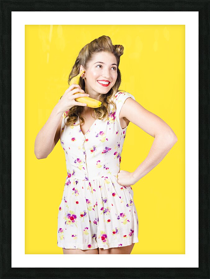 Retro pin up girl chatting on banana telephone Picture Frame print